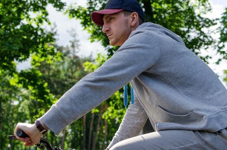 Young man with the bicycle in the parkの写真素材