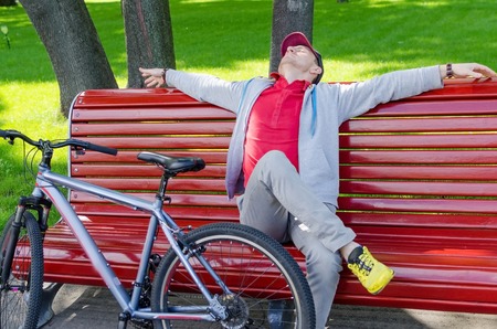 Young man with the bicycle in the parkの写真素材