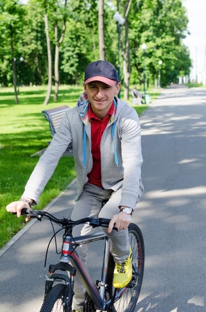 Young man riding a bicycle in the parkの写真素材
