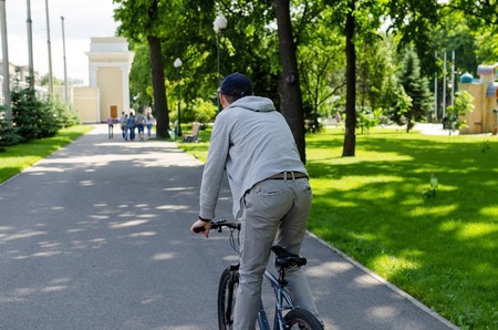 Young man with the bicycle in the parkの写真素材