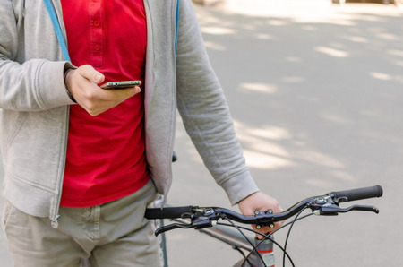 Young man with the bicycle in the park