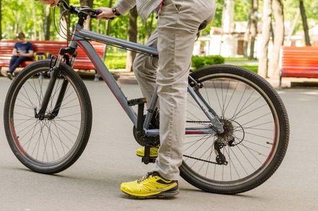 Young man riding a bicycle in the parkの写真素材