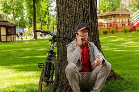 Young man with the bicycle in the parkの写真素材