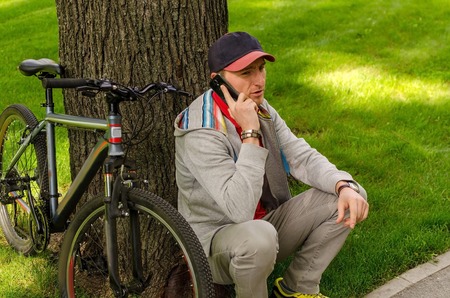 Young man with the bicycle in the parkの写真素材