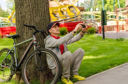 Young man with the bicycle in the parkの写真素材