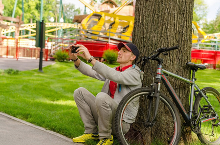 Young man with the bicycle in the parkの写真素材