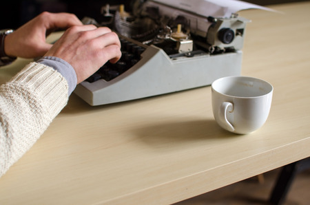 Close-up photo of typewriter and cup of coffeeの写真素材