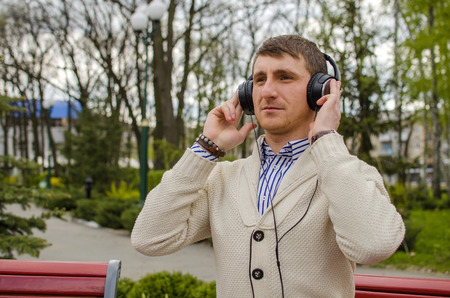 man in headphones is listening music with serious face
