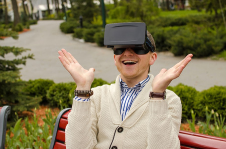 Young man in glasses spreads his arms to the sides