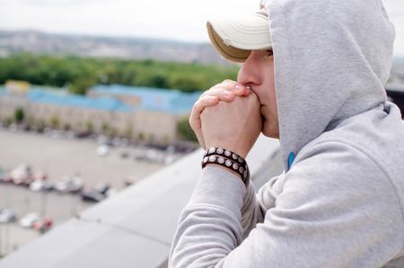 Young man is resting on the roof of the building