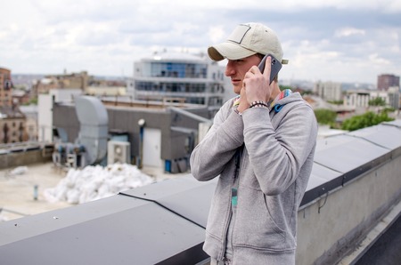 Young man using his black cell phoneの写真素材