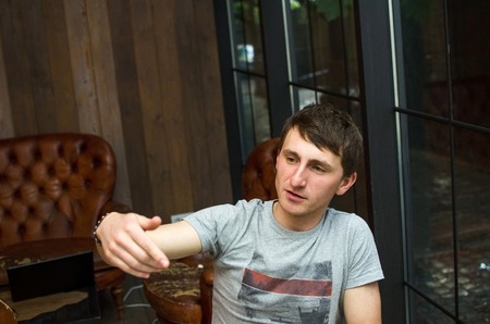 Young man is resting in the cafe