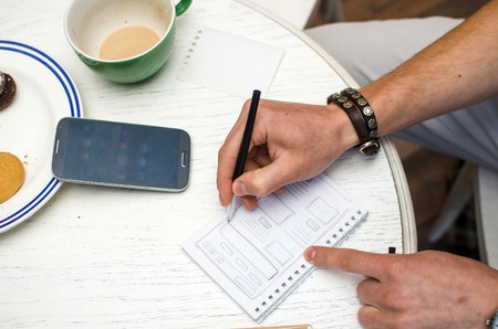 Young man using his black cell phoneの写真素材
