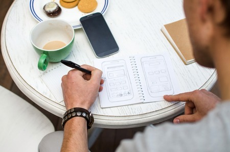 Young man using his notebook in hands