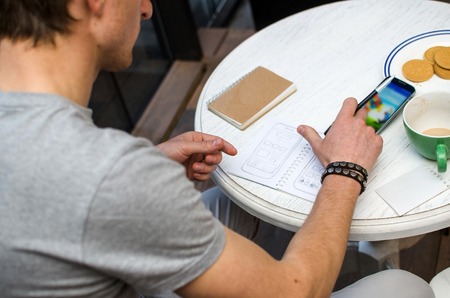 Young man using his notebook in hands