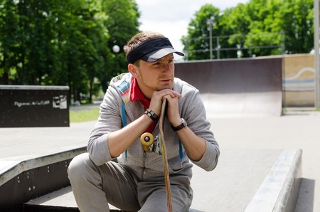 Young man with the skateboard in the park