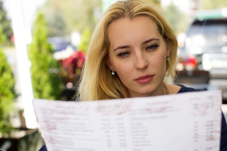 Young blonde woman choosing from the menu