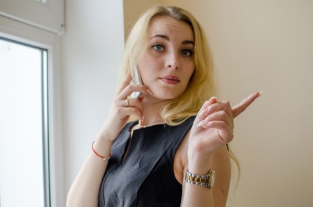 Young woman talking in the office on the phone