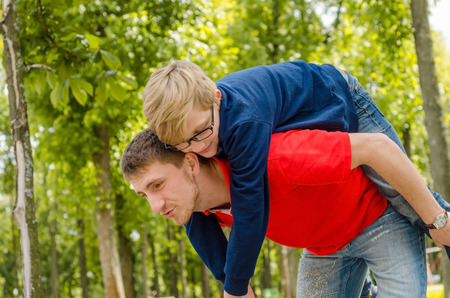 Young man with the teenager in the parkの写真素材