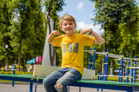 Teenager is sitting on the table in the park