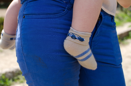 Young mother is walking with her small child in the parkの写真素材