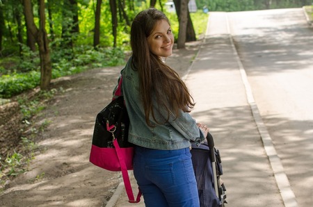 Young mother is walking with her small child in the park