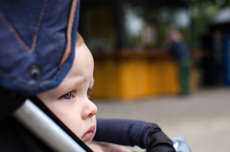Small baby boy in the carriage in the parkの写真素材