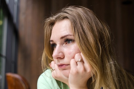 Sad young woman resting  in the cafe