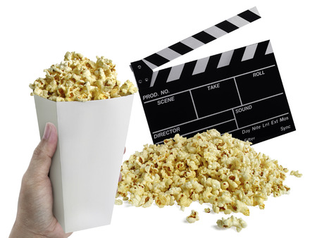hand with Popcorn, Movie clapperboard isolated on whiteの写真素材