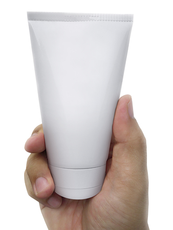 Human hand holding a cosmetics bottle  isolated on a white backgroundの写真素材