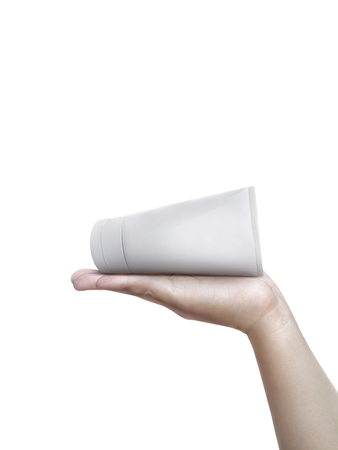 Human hand holding a cosmetics bottle  isolated on a white backgroundの写真素材