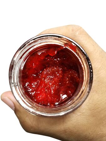 Glass jar with raspberry jam isolated on the white backgroundの写真素材