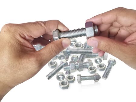 Nut and screw on hand on white background