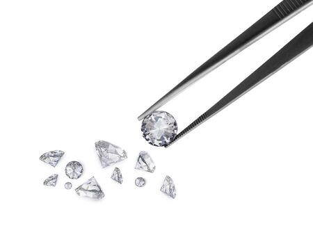 brilliant cut diamond held by tweezers