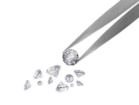 brilliant cut diamond held by tweezersの写真素材