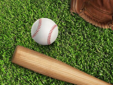 baseball, glove, ball and bat on field