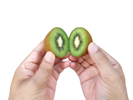Hand holds sliced half of kiwi fruit isolated on white backgroundの写真素材