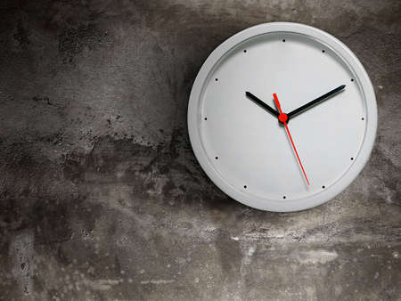 White clock hang isolated on old cement wall backgroundの写真素材
