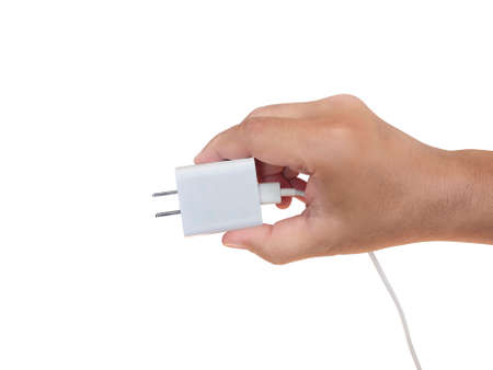 Hand holding a power plug smartphone white backgroundの写真素材