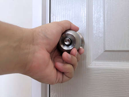 Hand on door knobs, Open door knobs