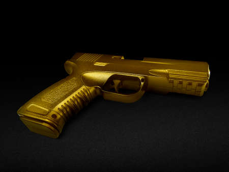 gun gold metal isolated on black backgroundの写真素材