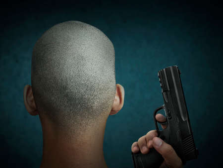 Bald man in with the gunの写真素材