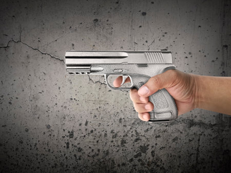 Killer with gun close up over grunge background with copyspace