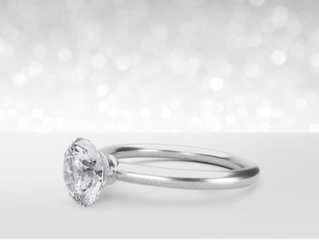 Close up of elegant diamond ring on white shining bokeh background. concept for chossing best diamond gem design. 3d renderの写真素材
