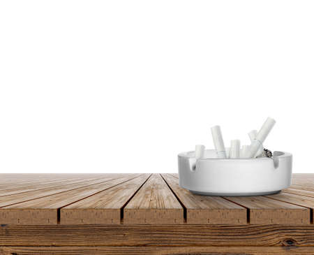 Ashtray full of cigarettes on wooden table top on white backgroundの写真素材