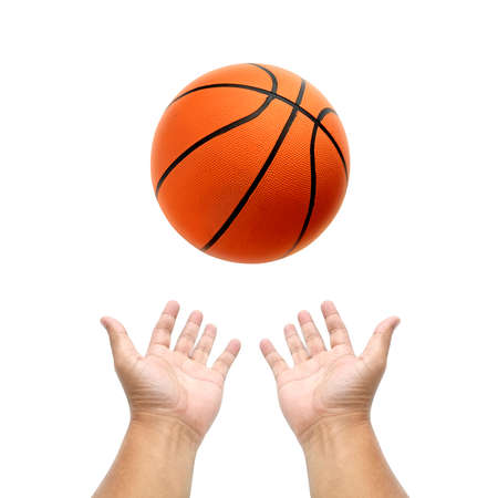 Hand holding basketball ball on white backgroundの写真素材