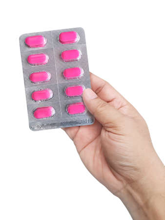 Hand holding medical drugs on white background. Pharmacy and medicine concept