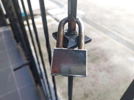 Old Locked Padlock Hanging On The Old Fashioned Metal Gate
