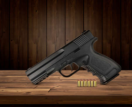 gun with bullets on wooden backgroundの写真素材
