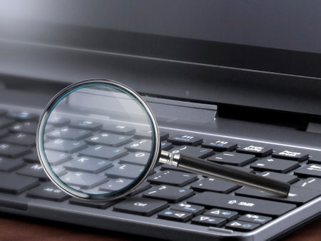 laptop computer with magnifying glass search conceptの写真素材